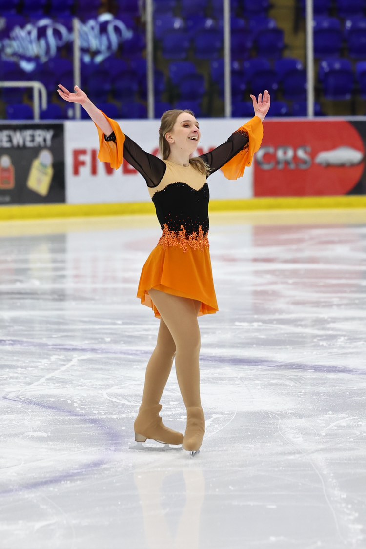 custom orange and black figure flowy skating dress by Sleek Edge