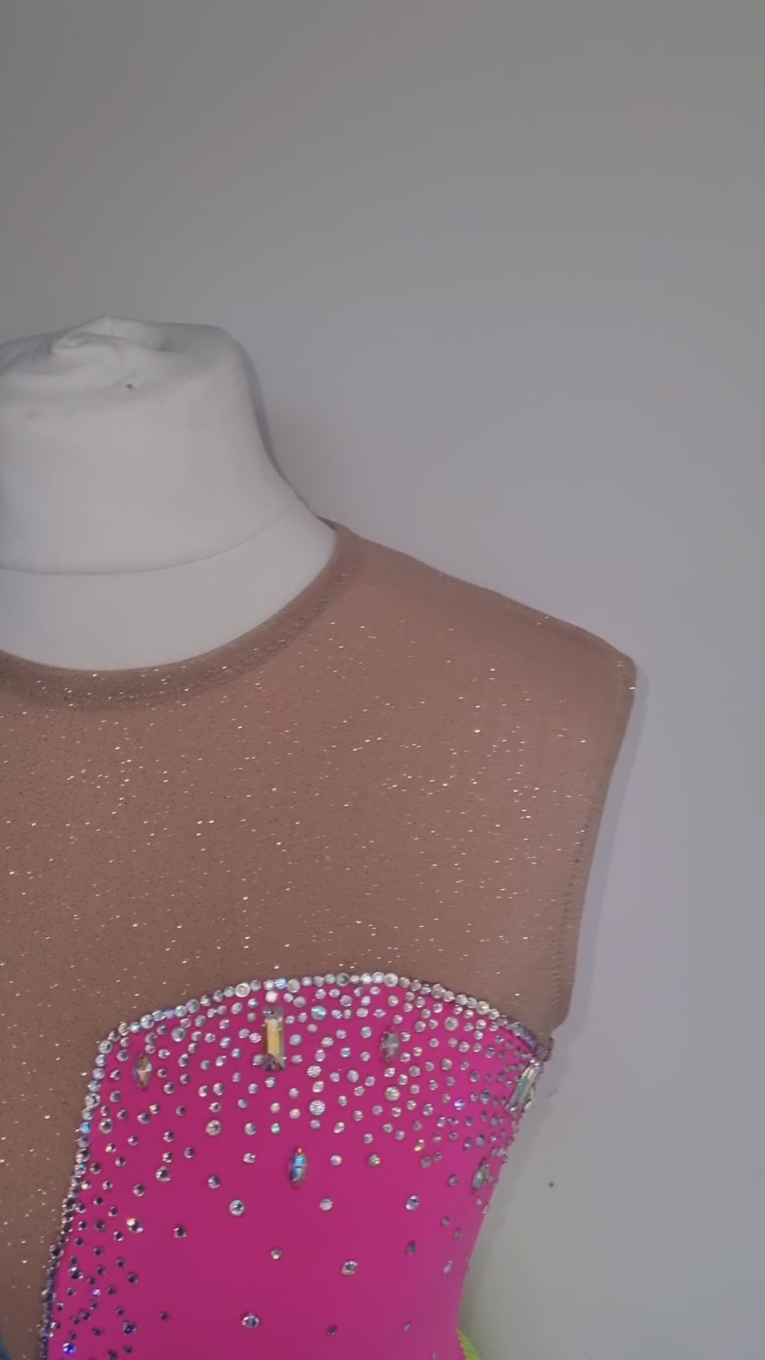 deep v shape custom figure skate dress by sleek edge. Pink and blue figure skate dress. tassel skirt figure skate dress